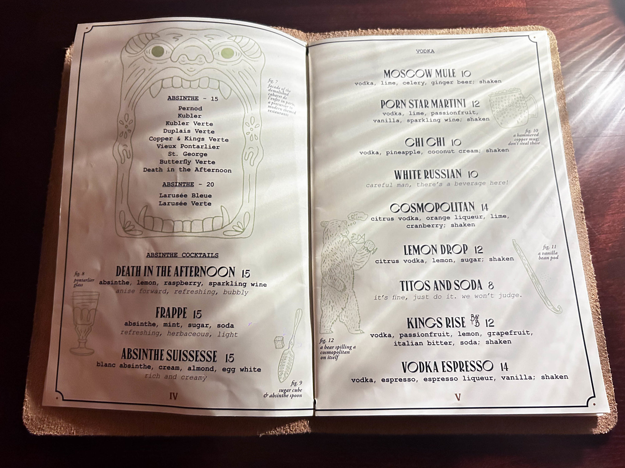 white two page drink menu in a brown book